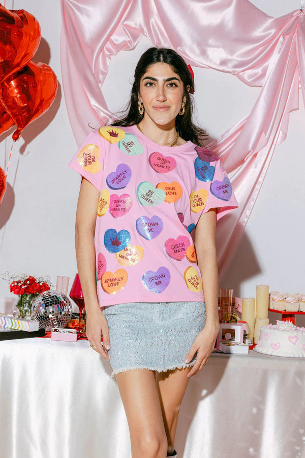 Woman wearing heart candy shirt made from sequins