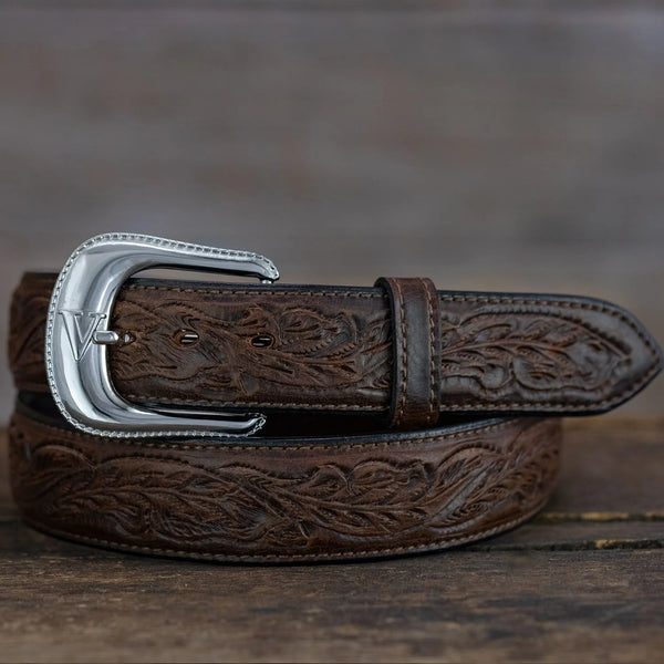 Brown leather belt with silver buckle on a wooden surface