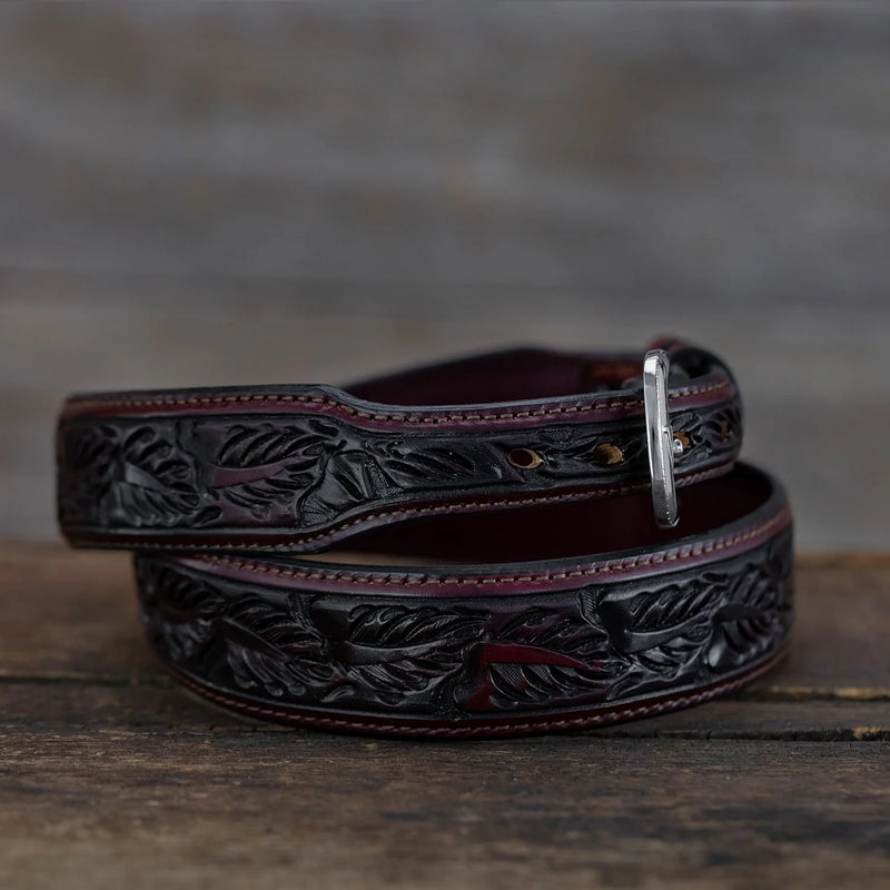 Deep cherry saddle color belt with silver buckle with "V' on it and tooled leaf detail