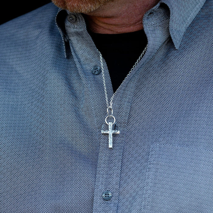 Silver cross necklace with ornate engraving