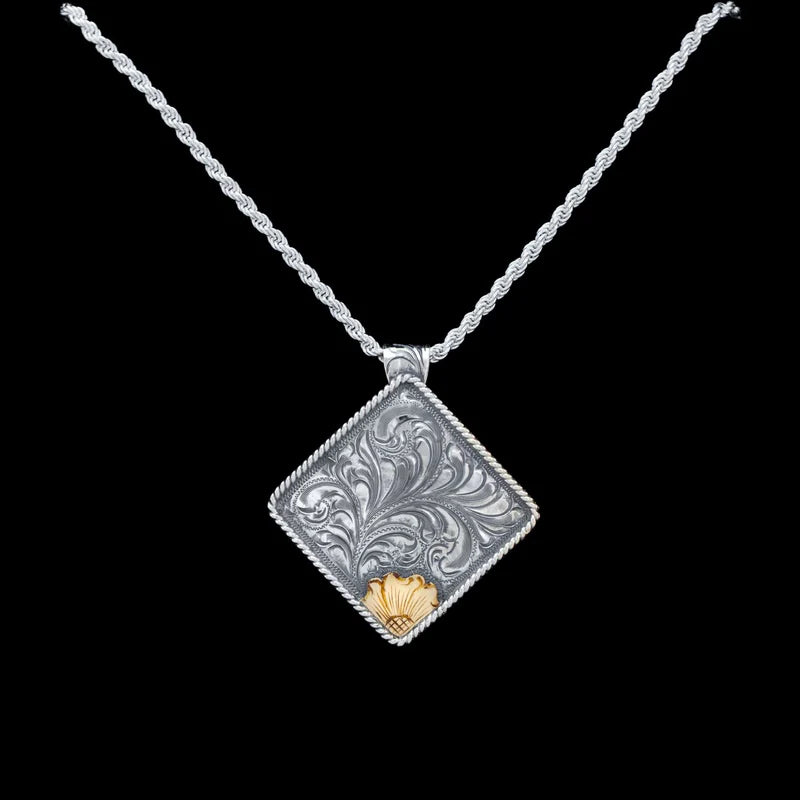 Sterling silver ornate square necklace with gold accent on the end