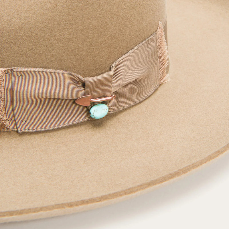 Tan fashion wool hat with pencil rim and turquoise rim on side and turquoise bead on ribbon hat band