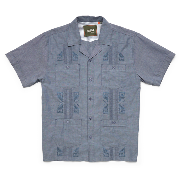 Blue guayabera short sleeve shirt with four pockets, collar and embroidery tribal pattern