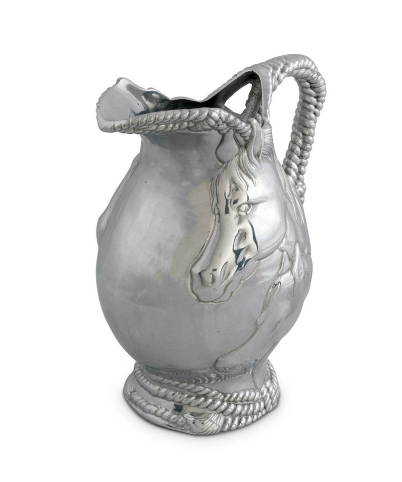 Metal pitcher with rope detail and two horse faces on the side