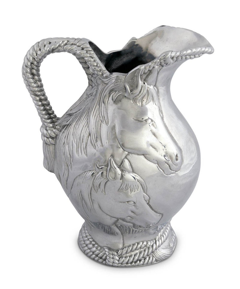 Metal pitcher with rope detail and two horse faces on the side