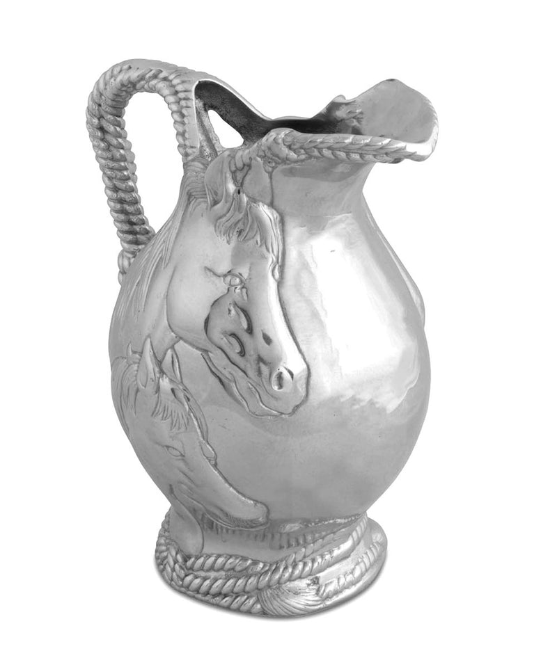 Metal pitcher with rope detail and two horse faces on the side