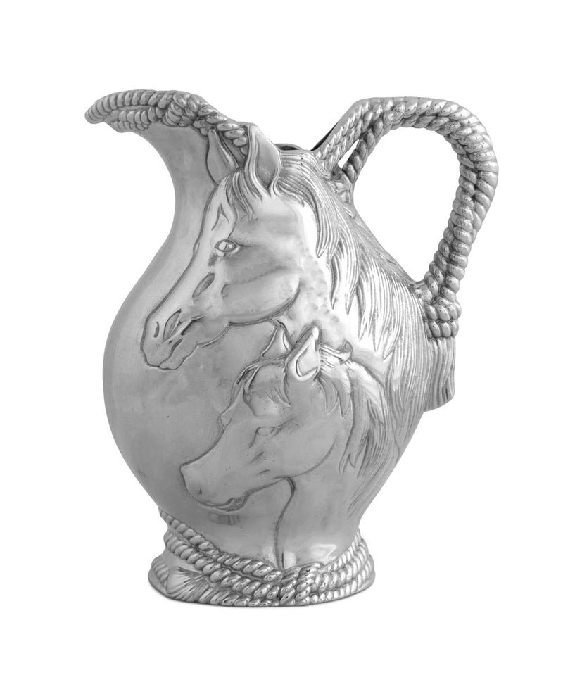 Metal pitcher with rope detail and two horse faces on the side