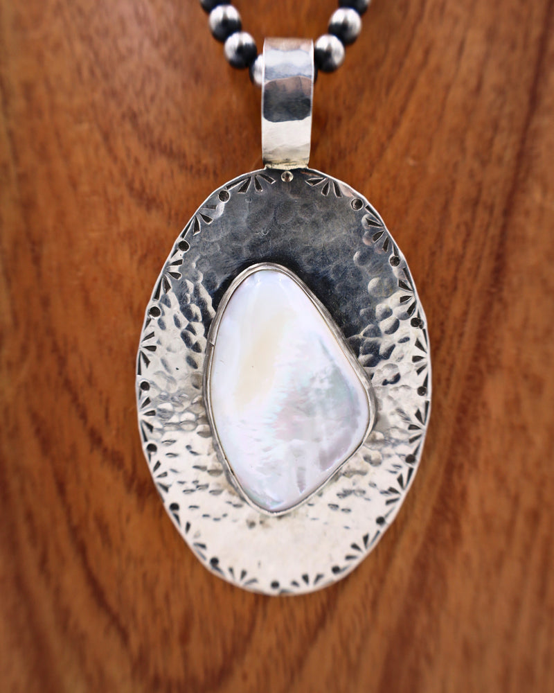 RICHARD SCHMIDT OVAL MOTHER OF PEARL WITH STAMPING PENDANT